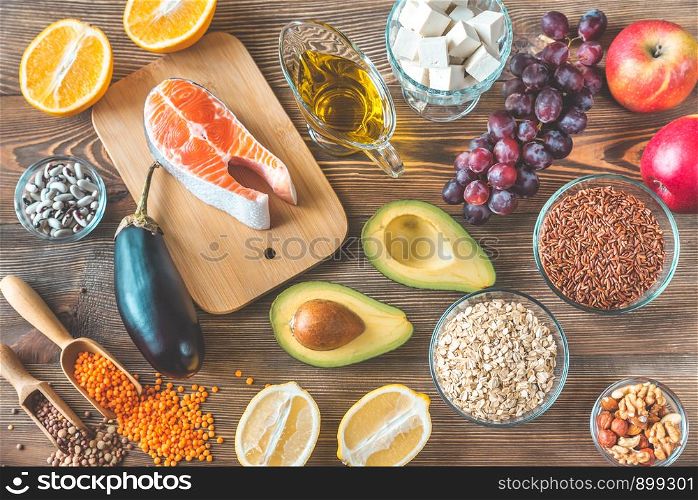 Foods providing low cholesterol diet on the wooden background