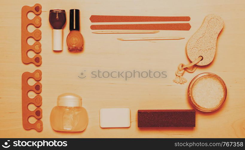 Foot care. Pedicure accessories set tools on wooden board background top view border frame with copy space. Pedicure accessories tools top view