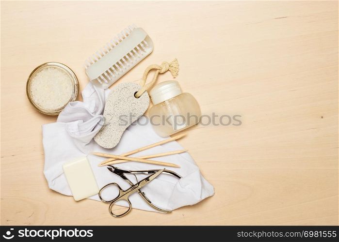 Foot care. Pedicure accessories set tools on wooden board background top view with copy space. Pedicure accessories tools top view