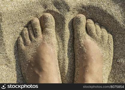 Foot in thongs on the beach