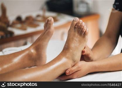 Foot reflexology massage. Female therapist massaging client&rsquo;s foot at wellness salon. Foot Reflexology Massage