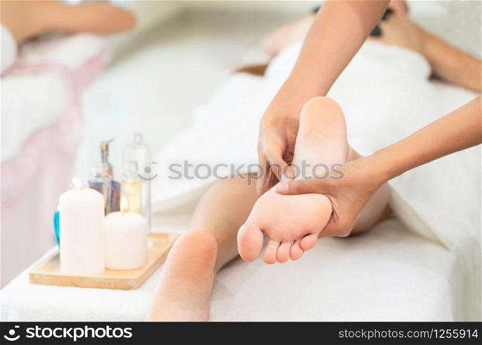 Foot spa massage treatment by professional massage therapist in luxury spa resort. Wellness, stress relief and rejuvenation concept.