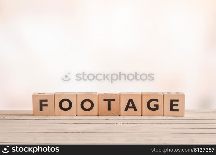 Footage sign made of wooden cubes on a desk