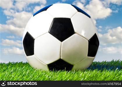 football ball is lying on grass on field