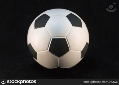 Football ball of white and black . Football ball of white and black on a black background