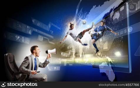 Football fan. Young man screaming in megaphone and watching football match