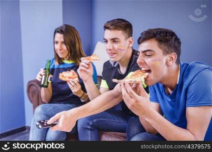 football fans couch eating pizza