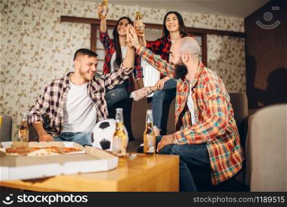 Football fans wathing tv broadcast at home, friends happy for the victory. Group of people cheer for their favorite team, decisive match. Cheerful company celebrate goal