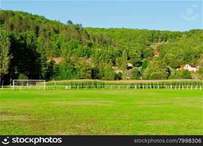 Football Field on the Background of Village in France