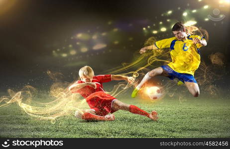 Football game. Two young football players struggling for ball