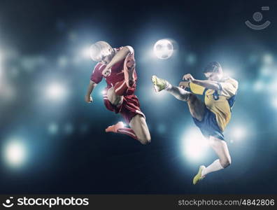 Football game. Two young football players struggling for ball