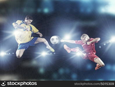 Football game. Two young football players struggling for ball