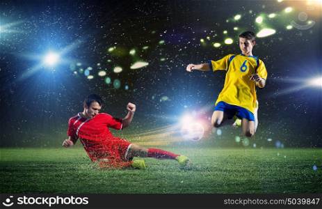 Football game. Two young football players struggling for ball