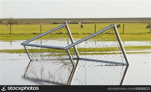 Football goal in a flooded field in Holland
