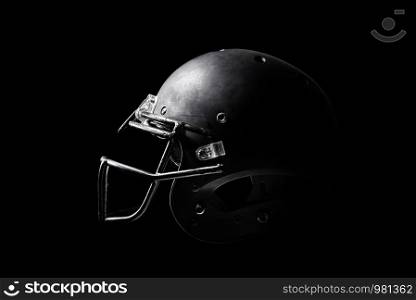 Football helmet on black background.