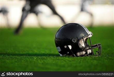 Football helmet on the field, selective focus