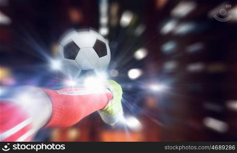 Football kick. Close up image of footballer foot kicking the ball