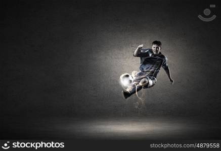 Football player. Football player in high jump taking ball
