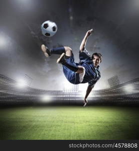 Football player. Image of football player at stadium hitting ball