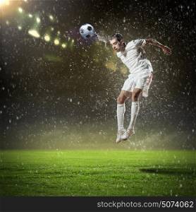 Football player. Image of football player at stadium hitting ball