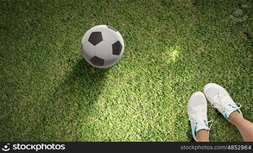 Football player. Top view of female football player on green grass