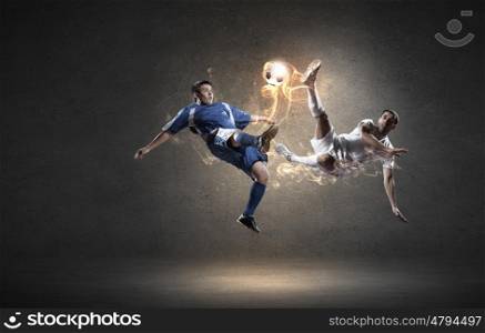 Football player. Two football players in jump fighting for ball