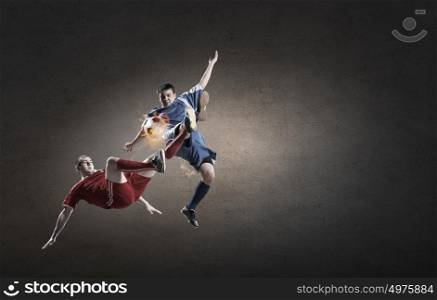Football player. Two football players in jump fighting for ball