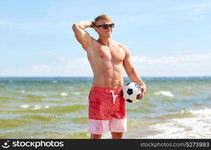 football, sport, fitness and people concept - young man with soccer ball on summer beach. young man with soccer ball on beach