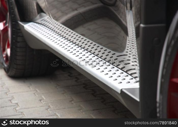 Footboard of the car of silvery color with a structure