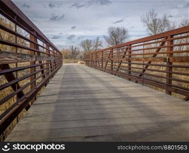 Footbridge on a recreational and commuting bike trail along the Poudre River in Fort Collins, Colorado, typical winter scenery