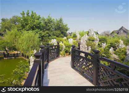 Footbridge over a pond, Yu Yin Shan Fang, Panyu, Guangzhou, Guangdong Province, China