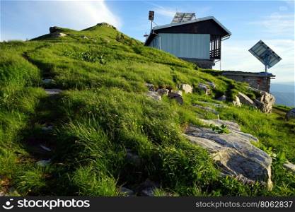 Footpath and mountain hut on the top of mount Porezen in Slovenia