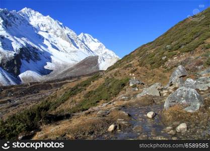 Footpath and river on the slope of mount Manaslu in Nepal