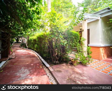 Footpath at the front of house with garden in resort, Thailand