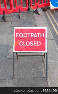 Footpath closed by road maintenance barrier sign