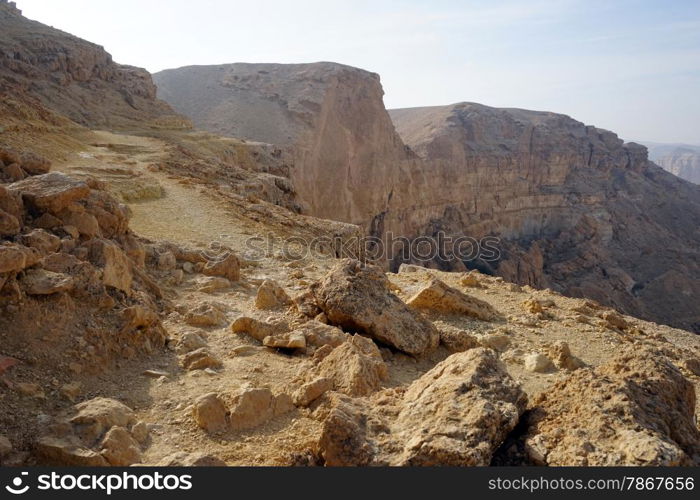 Footpath on the edge of crater Makhtesh Katan in Negev desert, Israel