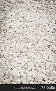 Footpath or sidewalk made of small white stones, background texture. Footpath made of small white stones, background texture
