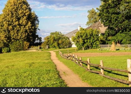 Footpath to home in the Mikhailovskoye village, autumn, sunset. Pushkinskiye Gory Reserve, Russia