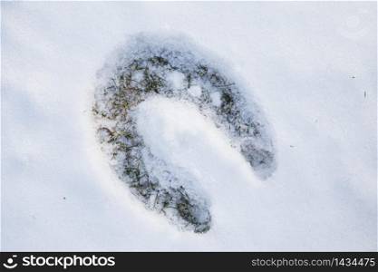 Footprint of horseshoe in snow. Footprint of a Horse in Snow