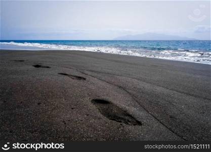 Footprints in black sand beach, Fogo Island, Cape Verde, Africa. Footprints in black sand beach, Fogo Island, Cape Verde
