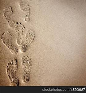 Footprints in the sand. Beach background with footprints in the sand