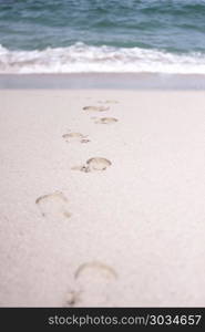 footprints in the sand. Traces of people in the sand of a beach