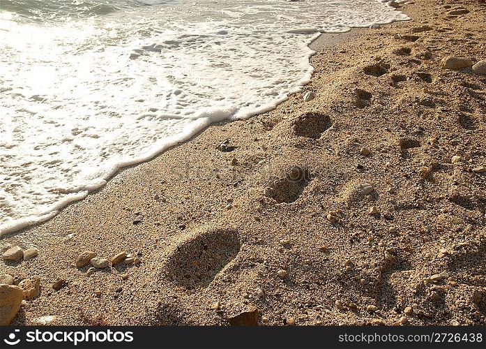 Footprints on the golden sandy tropical beach