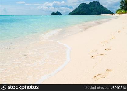 footprints on the white sand in Thailand Poda Island
