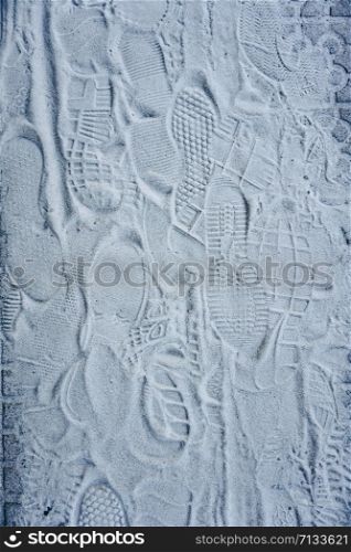 footprints on the white sand on the ground