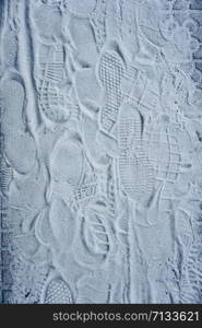 footprints on the white sand on the ground