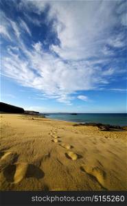 footstep in lanzarote spain rock stone sky cloud beach water musk pond coastline and summer