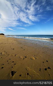 footstep in lanzarote spain rock stone sky cloud beach water musk pond coastline and summer