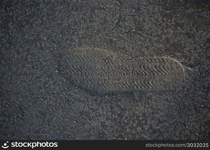 Footstep pattern on a concrete background. Footstep pattern seen on a concrete background