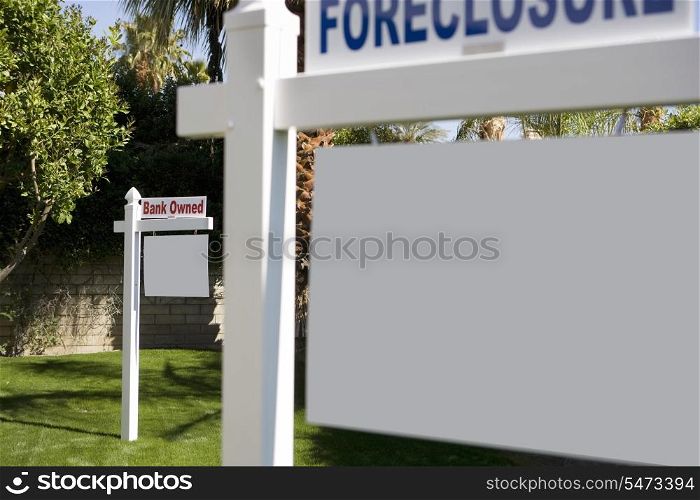 Foreclosure and Bank Owned signs in lawn